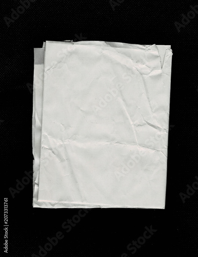 Blank crumpled folded white paper isolated on black background