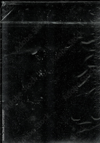 Grungy transparent plastic wrap texture isolated on black background