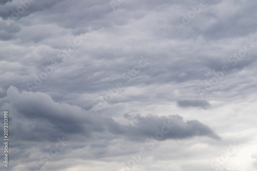 Overcast sky filled with layered gray storm clouds and soft textures, creating a moody, dramatic atmosphere that suggests approaching rain and the calm before a storm.