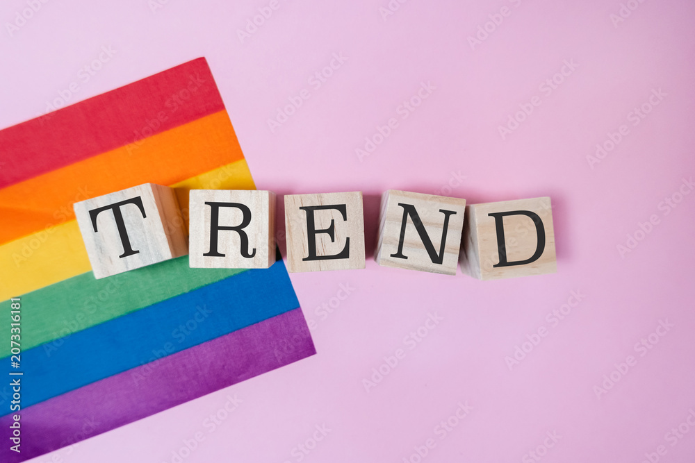 Naklejka premium LGBTQ Trend Concept with Rainbow Flag and Wooden Blocks