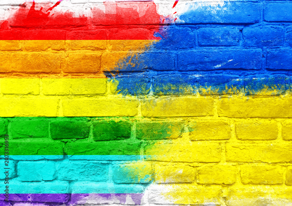 Fototapeta premium Rainbow Flag Painted on Brick Wall with Vibrant Colors