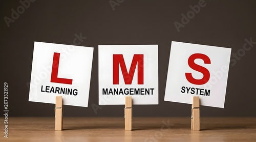 LMS Learning Management System Concept with White Cards on Wooden Clothespins on Dark Brown Background