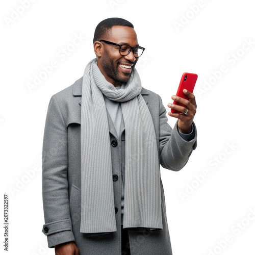 Smiling man wearing a scarf and glasses looks at his red smartphone with a