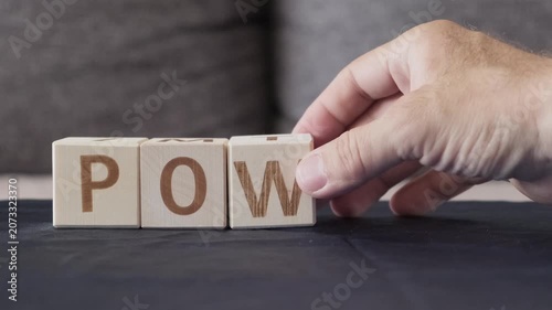 motivational word power, laying out  by hand from letters on wooden cubes, slow motion
