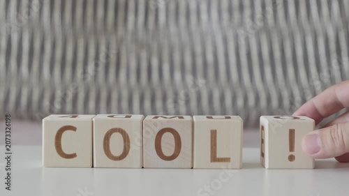 motivational word cool !, laying out  by hand from letters on wooden cubes, slow motion
