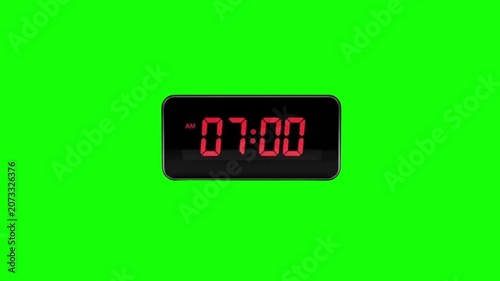 Digital alarm clock at 07:00 AM on green screen background. Red LED display electronic clock isolated for chroma key video overlay.