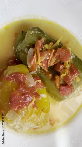 Bell peppers stuffed with meat and rice, stewed in tomato sauce. Delicious and healthy home cooking.