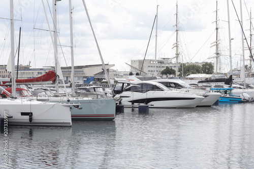 Boats docked in a marina on a cloudy day
