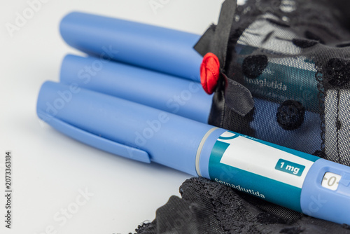 Εκτύπωση καμβά Blue semaglutide medication pen pack on black lace underwear over white backgrou