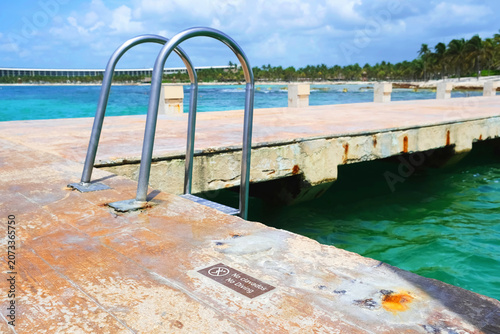 Dock with metal ladder over water.