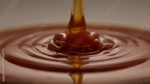 Thick Liquid Caramel Pouring into a Pool Creating Concentric Ripples