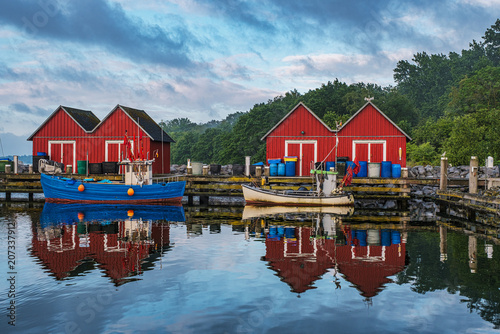 The idyllic fishermen's huts and fishing boats in the Tarnewitz fishing harbor on the Baltic Sea.