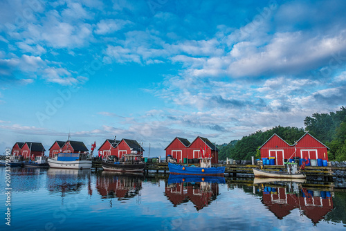 The idyllic fishermen's huts and fishing boats in the Tarnewitz fishing harbor on the Baltic Sea.