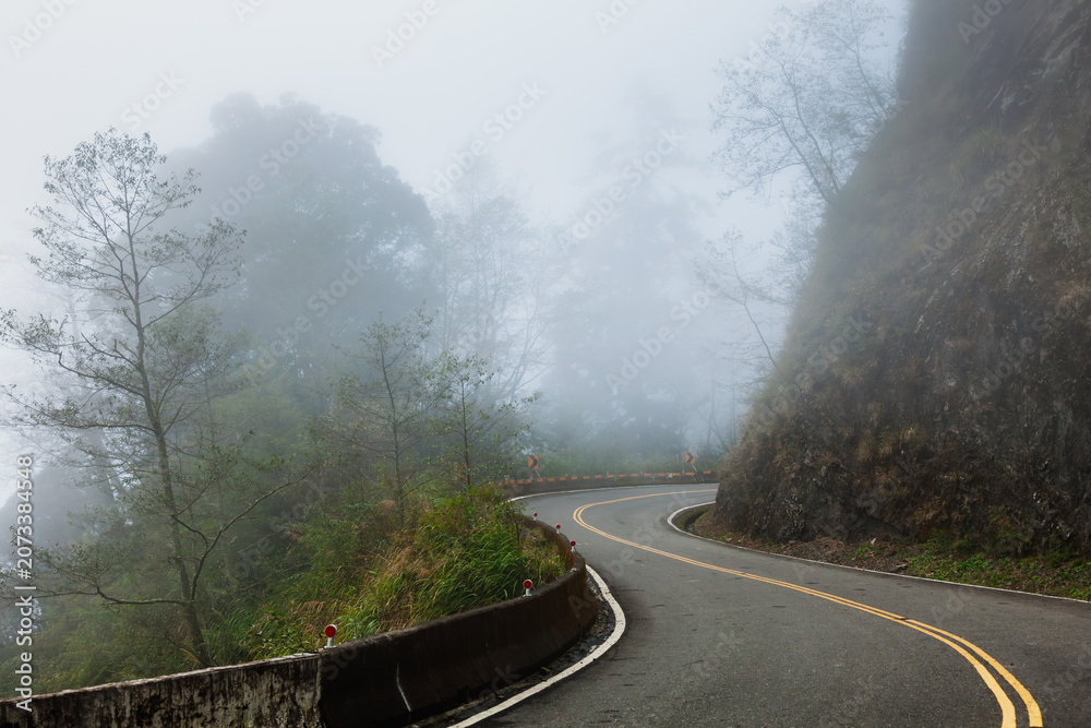 Fototapeta premium Misty Cliffside Road Toward Unknown Places