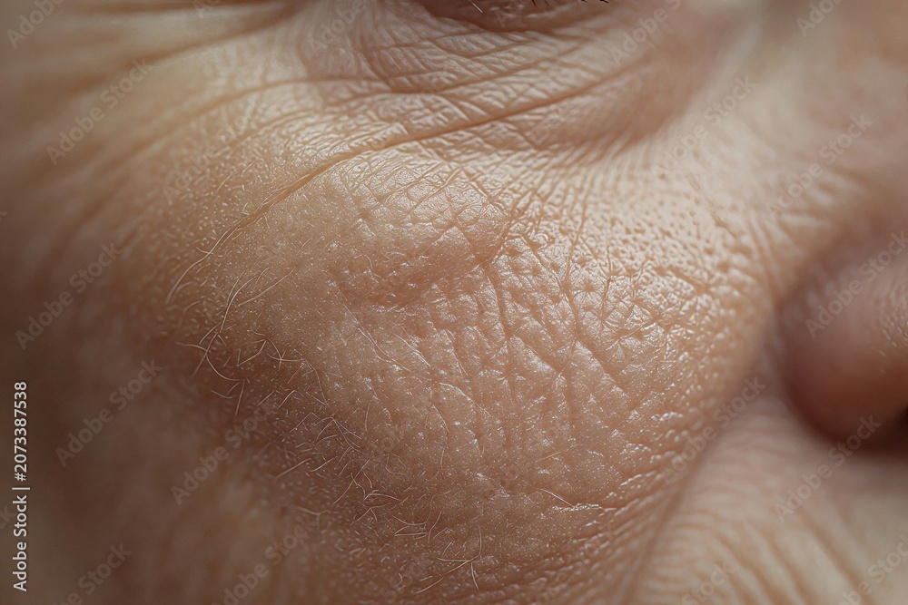 Naklejka premium Close up of woman face skin texture showing pores and fine line. Hormonal effect on skin health and aging. Dermatological concept for cosmetic treatment, skincare and beauty routine.