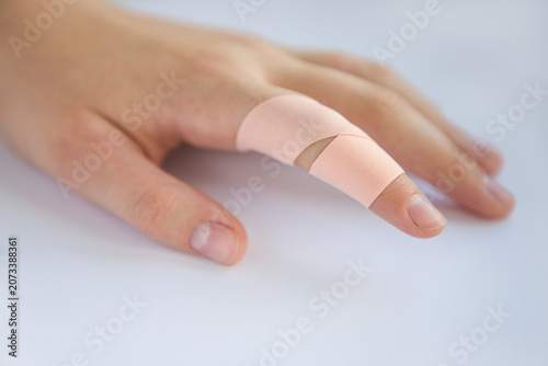 Fotografía Hand with adhesive bandage on white background, close-up