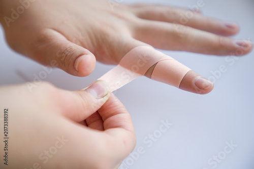 Canvas Print Close up of a bandage being applied to a patient's hand