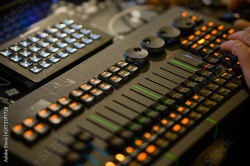 the hands of the dj mixer on the music mixer. close - up.