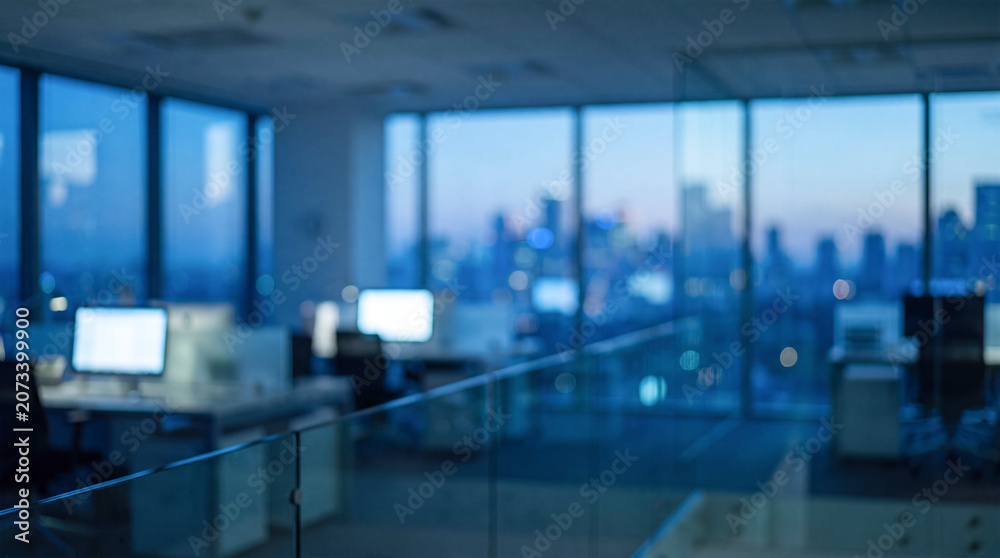 Fototapeta premium Blurry office interior with computers at twilight