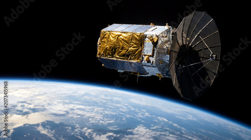 Communications satellite with parabolic antenna orbiting above Earth