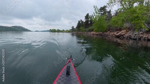 stern POV from a kayak - paddling on Horsetooth Reservoir in Fort Collins, Colorado, cloudy summer morning scenery 