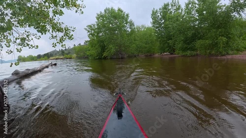 stern POV from a kayak - paddling on Horsetooth Reservoir in Fort Collins, Colorado, cloudy summer morning scenery 