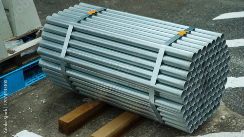 Bundle of galvanized steel pipes on wooden supports