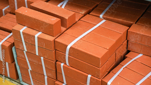 Bundled red clay bricks stacked at a supply store