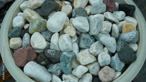 Decorative colorful river pebbles in a flower pot
