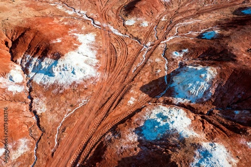 Aerial View of Red Desert Landscape with Tire Tracks