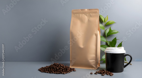 Brown coffee bag with coffee beans and a black cup on a gray surface