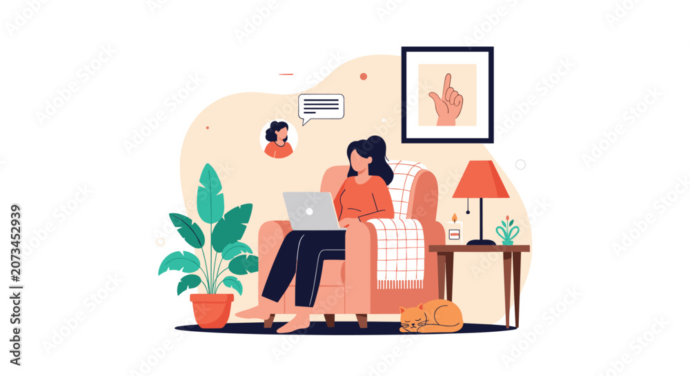 Fototapeta premium Freelance woman working from home on a laptop while relaxing in an armchair with her sleeping cat right beside her.