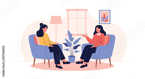 Two women sitting in comfortable armchairs having a friendly conversation or a professional psychotherapy session.