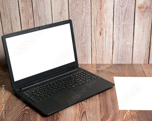 laptop with white screen on wooden table