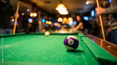 Valokuva Close-up of number 12 pool ball on green table in a bar