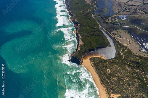 Princetown aerial view of coastal shoreline and rolling waves and sandy beach, Victoria Australia