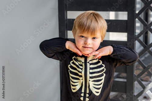 Принти на полотні Cute Little Boy with Down Syndrome Wearing Skeleton Halloween Costume and Smilin