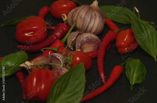 Fresh ripe tomatoes with garlic and basil ready for cooking