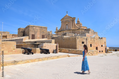Woman in Blue Dress Exploring the Victoria Citadel in Gozo, Malta