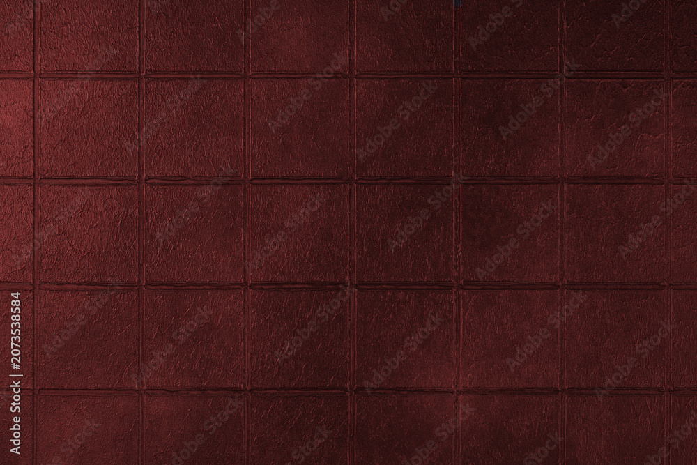 Fototapeta premium Dark red ceramic tile texture background with square pattern and subtle grunge surface. Abstract geometric wall backdrop with textured tiles and copy space. Interior element, vintage design