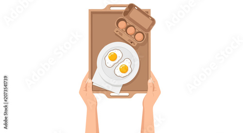 A pair of hands holding a wooden breakfast tray with fried eggs and a carton.