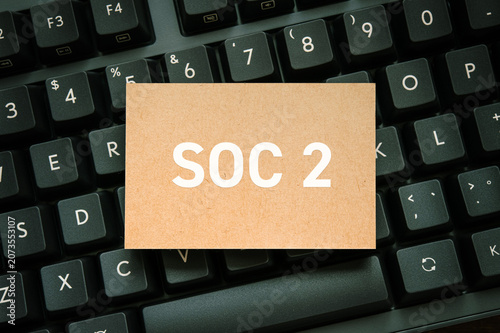 SOC 2 security compliance — critical cloud security certification concept for IT audit article, card on black keyboard background