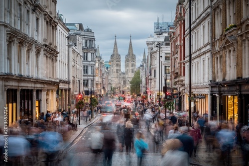 A bustling London street scene is captured with motion blur, showcasing the city's vibrant energy.