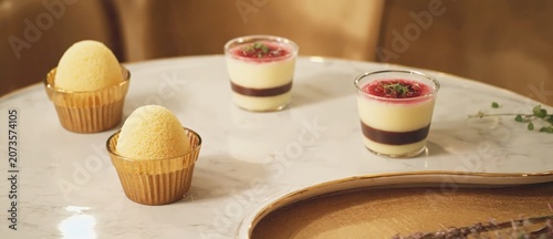 Gourmet desserts fruit sorbet and layered desserts on a table setting