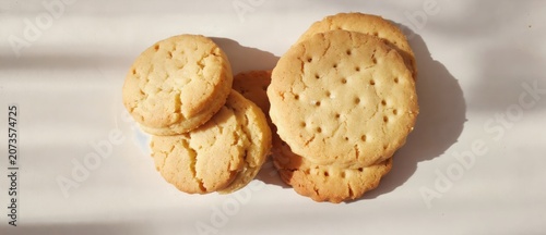 Close up of golden brown biscuits arranged on a neutral simple background