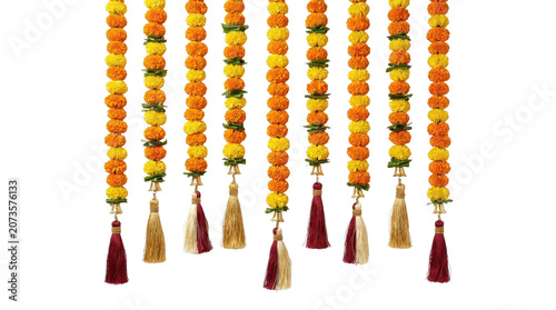Vibrant orange and yellow flower garlands with colorful tassels hang against a white background.