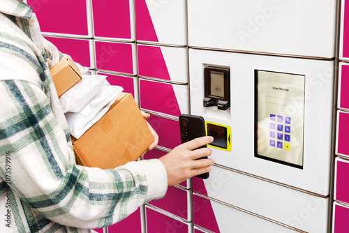 Fotografie Parcel pickup at a self-service terminal parcel locker