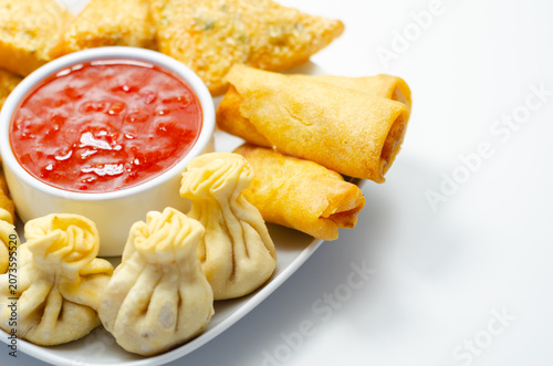 Golden dumplings rest beside crispy spring rolls