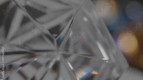 Intricate abstract detail of a clear, faceted glass surface, capturing brilliant light reflections and refractions that create mesmerizing geometric patterns and a captivating visual texture