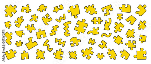 Fotografie Scattered Yellow Puzzle Pieces - Connecting Abstract Shapes for Solutions